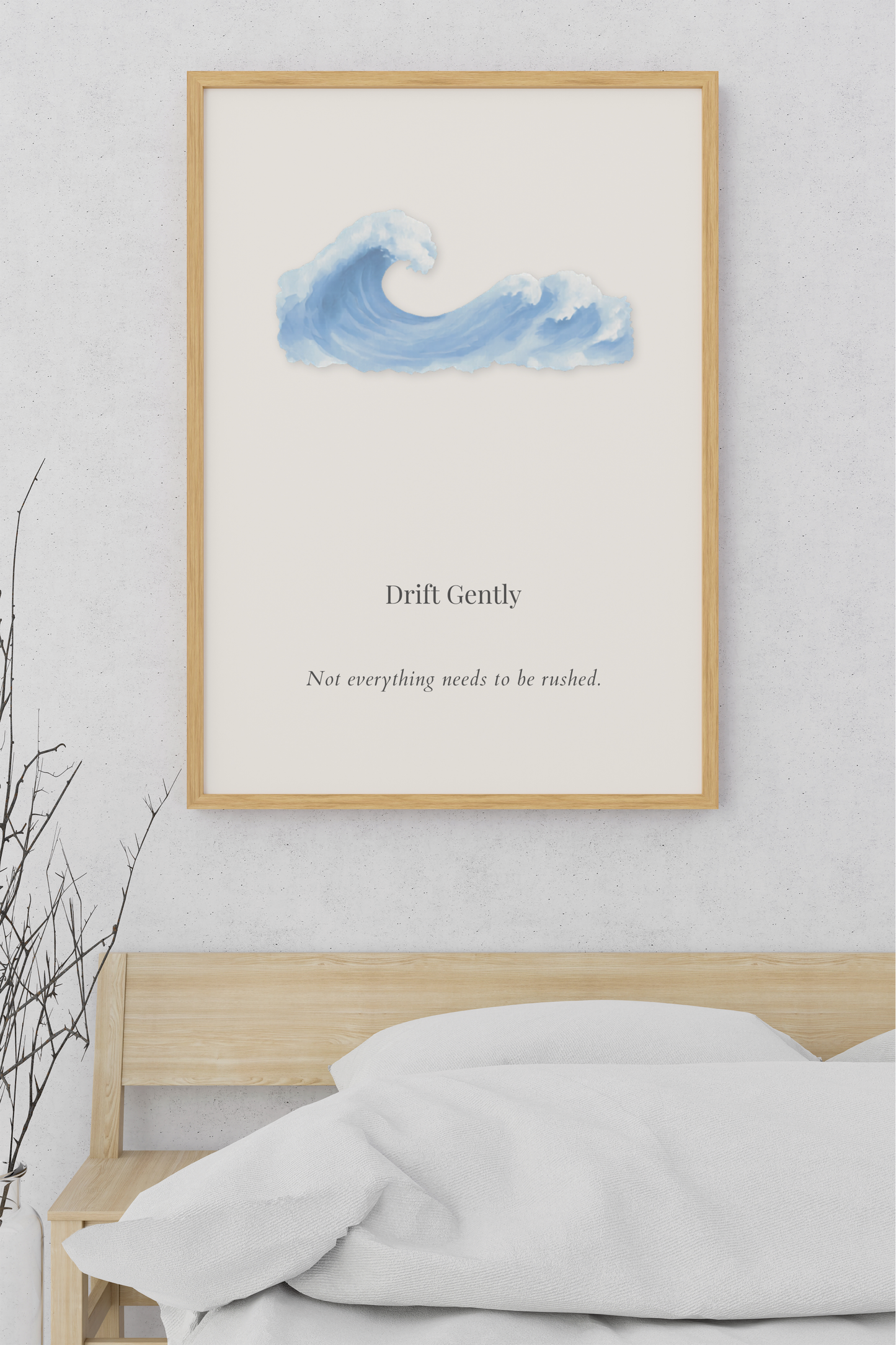 Drift Gently minimalist coastal wall art featuring a soft watercolor ocean wave displayed above a light wood bed in a calming neutral bedroom.