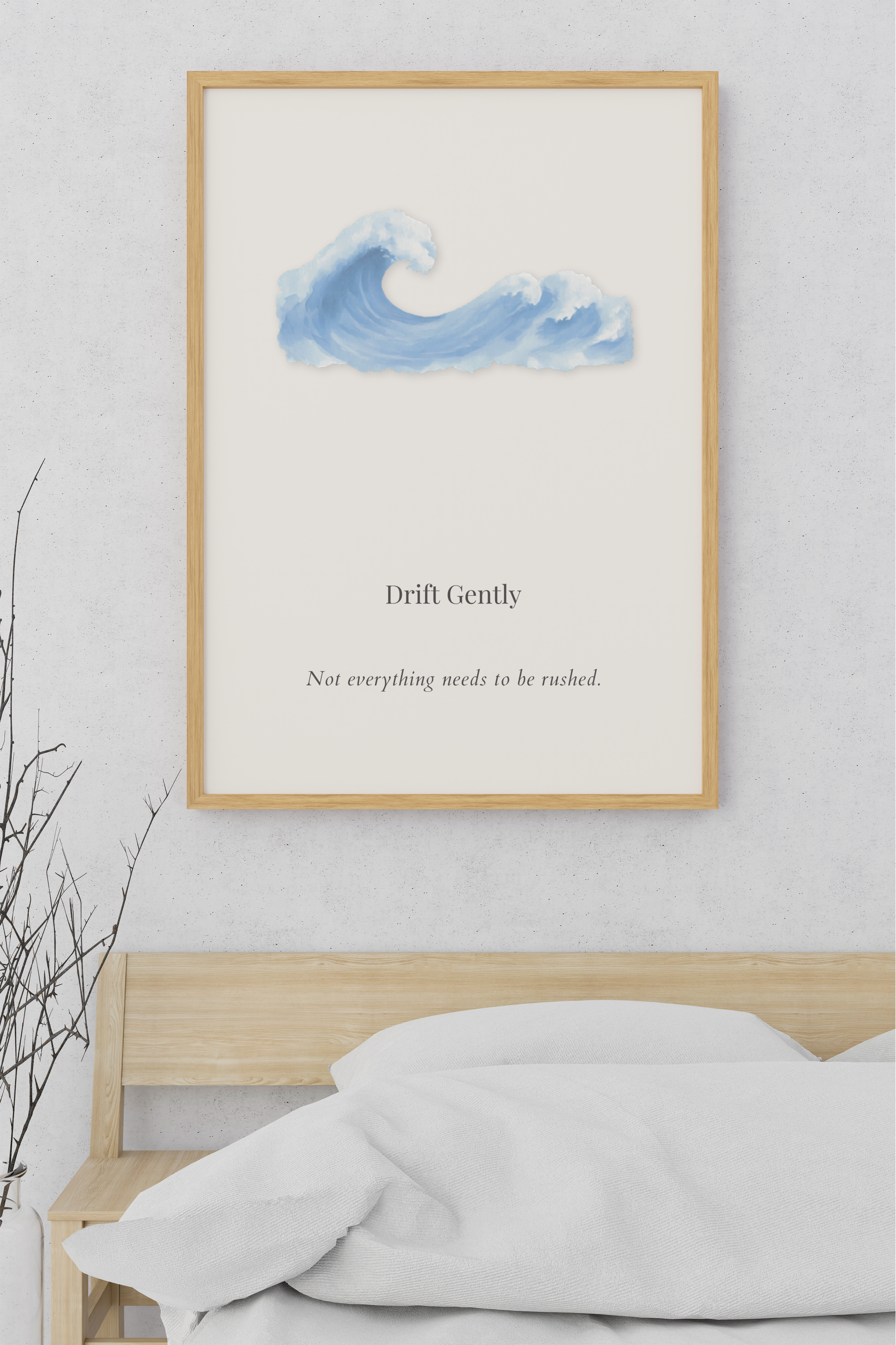 Drift Gently minimalist coastal wall art featuring a soft watercolor ocean wave displayed above a light wood bed in a calming neutral bedroom.